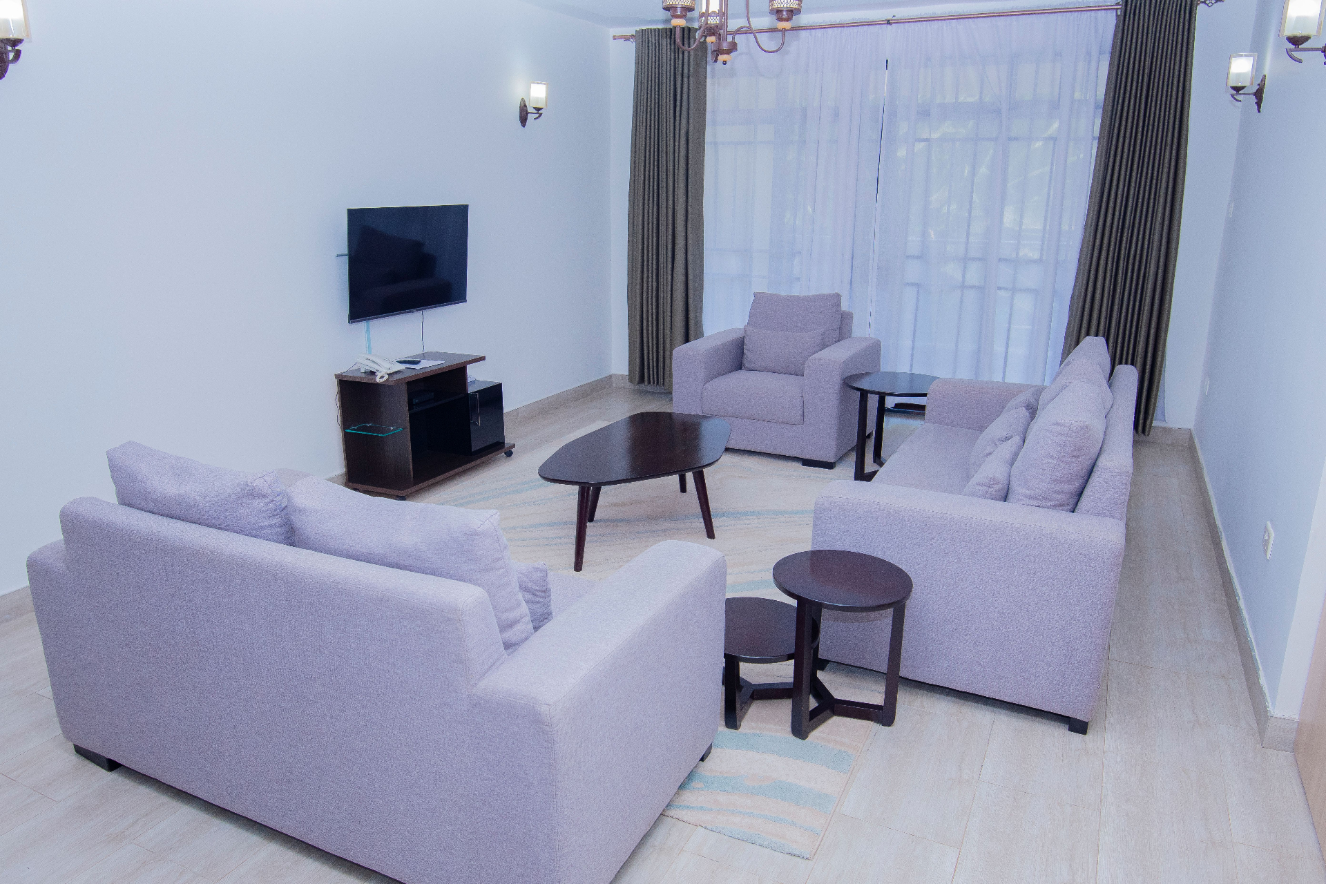 Two-Bedroom Furnished – large lounge with TV and seating