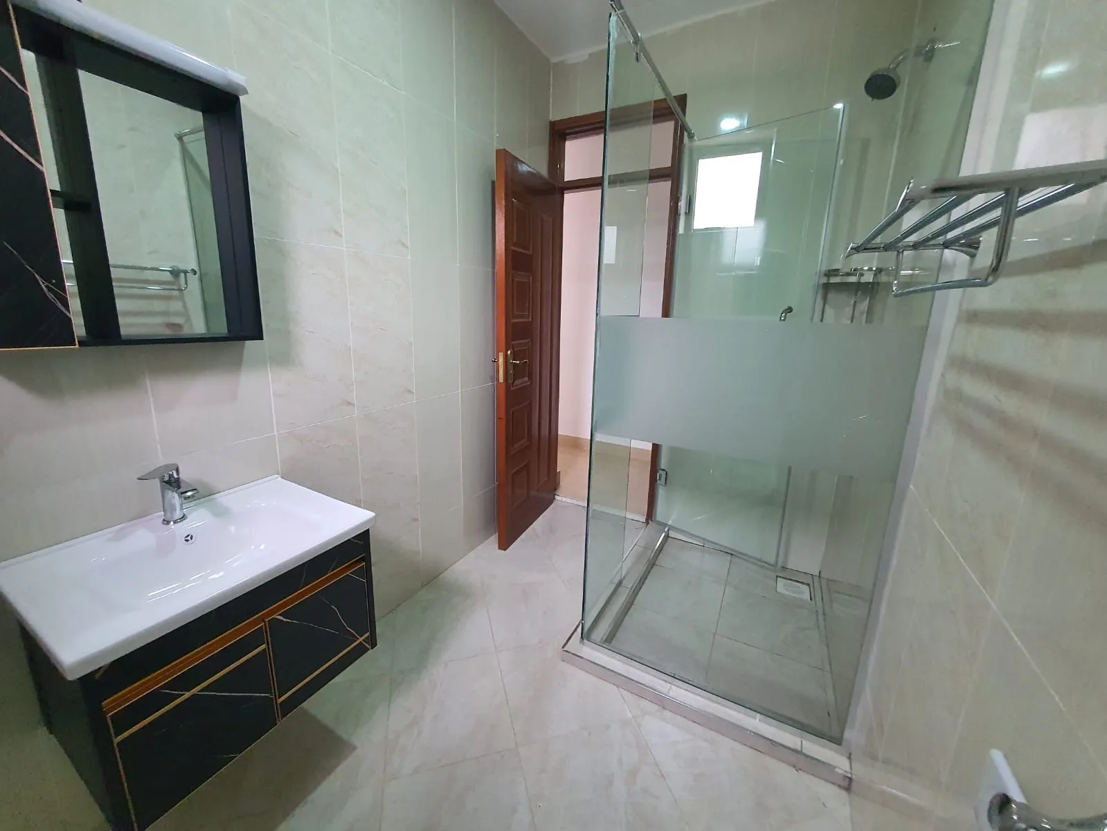 Two-Bedroom Furnished – modern bathroom with glass shower enclosure and vanity