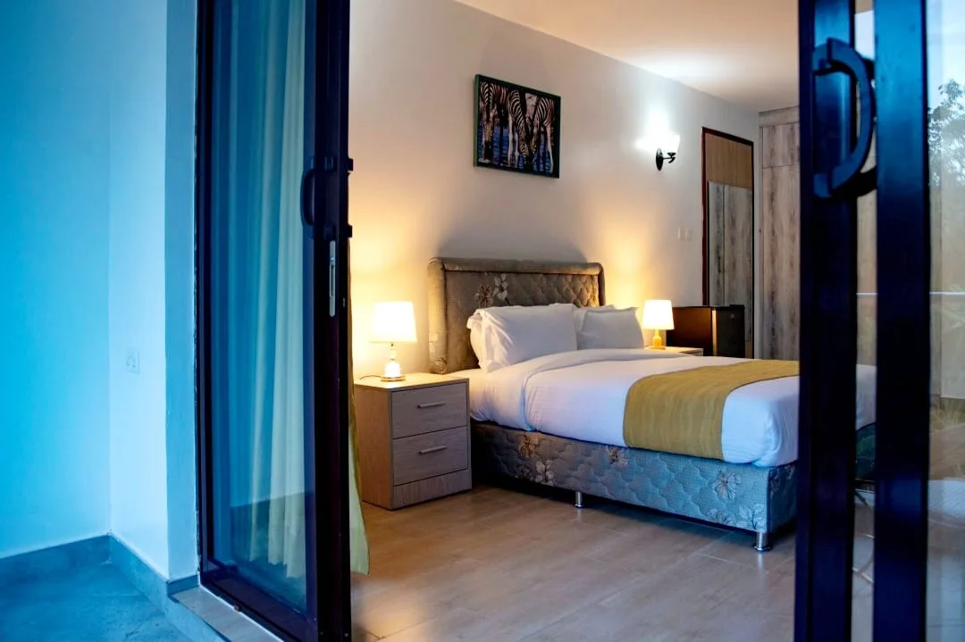 Two-Bedroom Furnished – warm bedroom with soft lighting and garden outlook